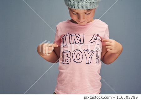 Hands, child and point at print on shirt for gender identity, style and edgy fashion model by blue background. Boy, toddler and kid with pink clothes for choice, learning and show text with promotion 116305789