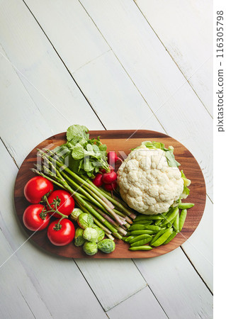 Home, table and vegetable on cutting board for cooking with diet, nutrition and healthy living. Fresh, food and kitchen counter with organic or vegetarian meal for wellness, wellbeing and self care 116305798