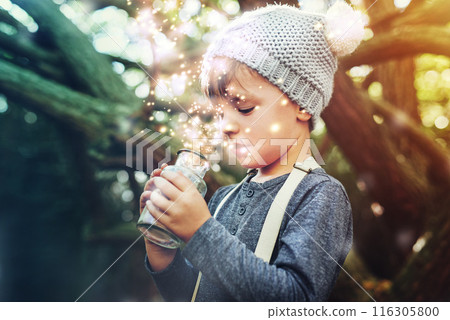 Magic, jar and light outdoor in nature with glow, shine and young child playing in forest. Boy, sparkle and happy in woods as dream with fantasy for unique mystical fairy, folklore and pixie dust 116305800