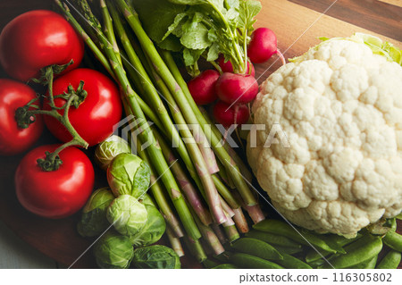 Food, table and vegetable on cutting board for cooking with diet, nutrition and healthy living. Fresh, crops and closeup with organic or vegetarian meal for wellness, wellbeing and self care Food, table and vegetable on cutting board for cooking with diet, nutrition and healthy living. Fresh, crops and closeup with organic or vegetarian meal for wellness, wellbeing and self care 116305802