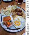 FRIED RICE WITH CHICKEN CUTS, AND TOPING OF FRIED EGG, EMPING, AND ALSO PICKLES AND SAMBAL. 116305876