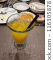 a glass of lemon juice and a spoon 116305878