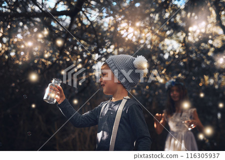 Fireflies, jar and outdoor in nature at evening time with glow, shine and children playing in forest. Boy, girl and happy in woods as siblings with fantasy for unique magic light and mystical fairy Fireflies, jar and outdoor in nature at evening time with glow, shine and children playing in forest. Boy, girl and happy in woods as siblings with fantasy for unique magic light and mystical fairy 116305937