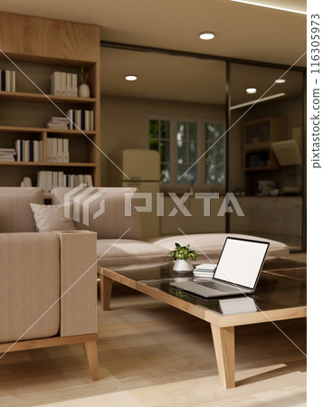 A modern living room featuring a laptop on a coffee table, a comfortable couch, and home decor. 116305973