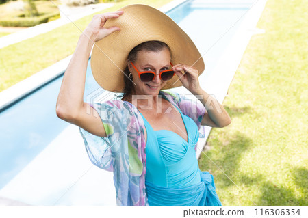 Outdoors, Caucasian senior female wearing a blue swimsuit Outdoors, Caucasian senior female wearing a blue swimsuit 116306354