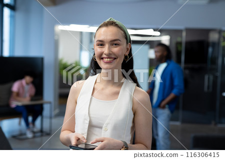 In modern office, diverse young team working with blue background 116306415