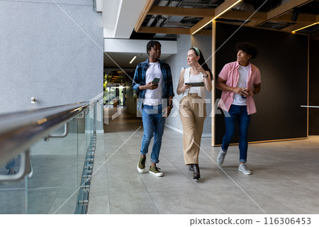 In modern office, diverse young team exchanging ideas on smartphones In modern office, diverse young team exchanging ideas on smartphones 116306453