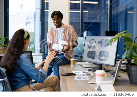 In modern office, diverse young team exploring virtual reality 116306469