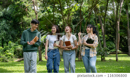 A group of cheerful Asian students are enjoying talking and laughing while walking in the park. A group of cheerful Asian students are enjoying talking and laughing while walking in the park. 116306800
