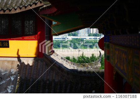 Chinese Buddhist temple built by Yangtze river, overlooking urban city 116307188