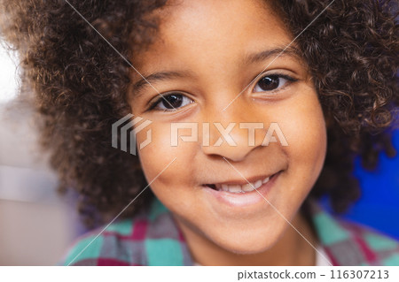 In school, young biracial boy is smiling at camera In school, young biracial boy is smiling at camera 116307213