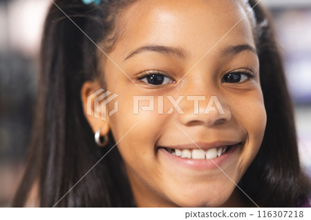 In school, young African American girl is smiling at camera 116307218