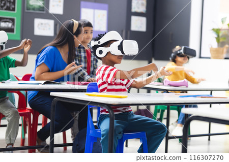 In school, diverse group of young students wearing virtual reality headsets in the classroom 116307270