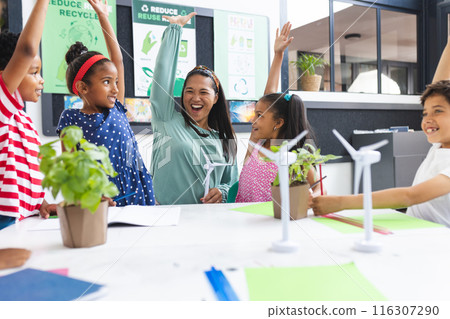 In school, middle-aged Asian teacher and diverse children are celebrating in the classroom 116307290
