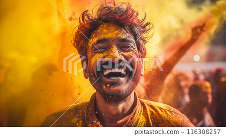 Man with a beaming smile covered with yellow Holi powder with a festive background 116308257