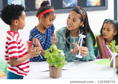 A diverse group studies wind turbines in classroom 116308729