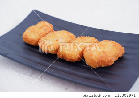 nuggets on a black plate 116308971