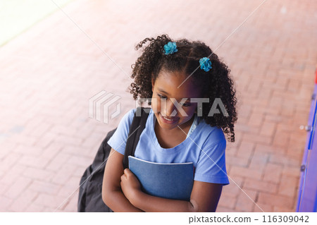 Biracial girl stands ready for school 116309042
