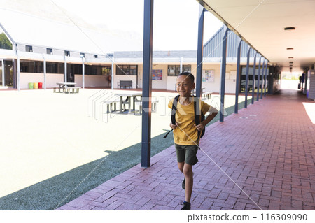 Biracial boy smiles at school, with copy space 116309090