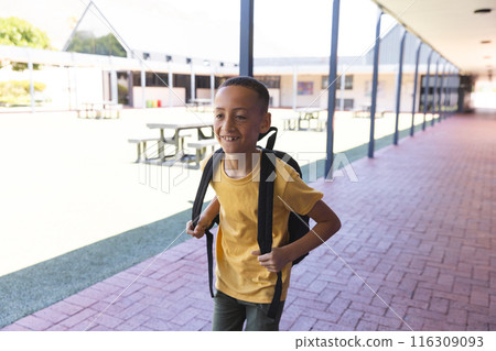 Biracial boy smiles at school, with copy space 116309093