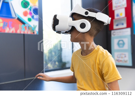 Biracial boy explores virtual reality at school Biracial boy explores virtual reality at school 116309112