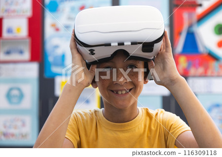 Biracial boy tries on virtual reality headset in school Biracial boy tries on virtual reality headset in school 116309118