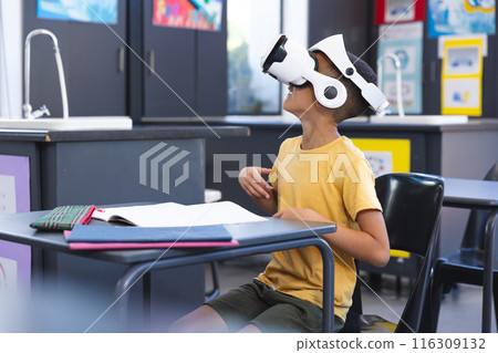 Biracial boy explores virtual reality in school Biracial boy explores virtual reality in school 116309132