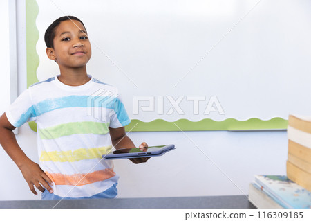 Biracial boy in a classroom at school, with copy space Biracial boy in a classroom at school, with copy space 116309185