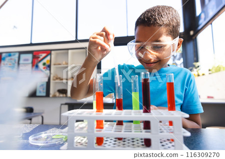Biracial boy engages in a science experiment at school Biracial boy engages in a science experiment at school 116309270