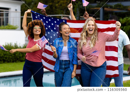 Portrait of happy diverse friends with flags of usa in garden Portrait of happy diverse friends with flags of usa in garden 116309360