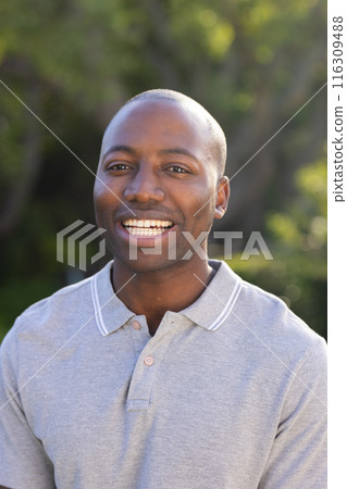 Outdoors, young African American man smiling warmly 116309488
