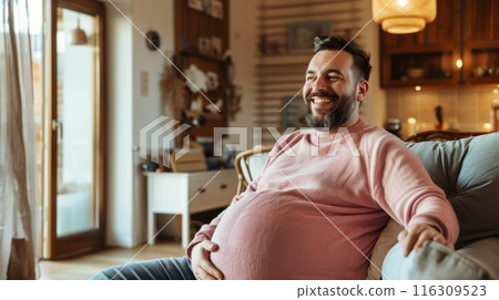 Fat lazy man on sofa at home wearing warm sweater. Disappointment and gain. 116309523