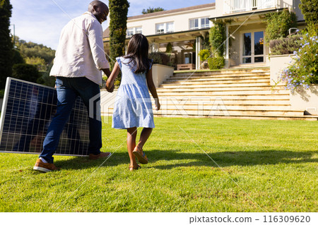 Outdoors, diverse father and daughter walking towards modern house Outdoors, diverse father and daughter walking towards modern house 116309620