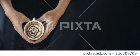 Banner Coffee barista pour espresso shot and make latte art hot coffee cup. Cappuccino with milk in italian coffee shop cafe. Banner Close up hands of barista make brown latte art with copy space 116309709