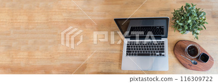 Banner Top view office desk laptop and coffee cup on wood table copy space.  Panorama tabletop notebook laptop coffee cup for officer display empty space wooden background workspace full banner design 116309722