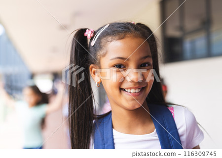 Biracial student smiling with long hair tied in pigtails 116309745