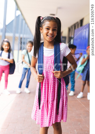 Students, including biracial and African American children, smiling with backpacks Students, including biracial and African American children, smiling with backpacks 116309749