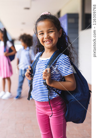 Biracial girl smiling with backpack, ready for school Biracial girl smiling with backpack, ready for school 116309768