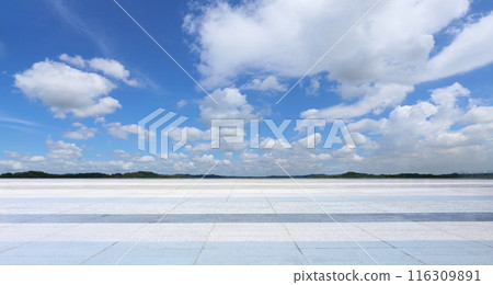 Empty square ground with blue sky and clouds background Empty square ground with blue sky and clouds background 116309891