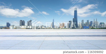 Empty square floor is providing space for product placement with modern city skyline in the background Empty square floor is providing space for product placement with modern city skyline in the background 116309892