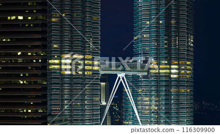 Skybridge connecting two illuminated skyscrapers at night in kuala lumpur 116309900