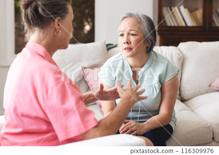 Diverse senior female friends having serious conversation about emotions 116309976