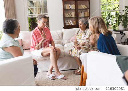 Diverse senior female friends having serious conversation about emotions 116309981