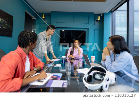 Diverse team meets in modern conference room for business collaboration Diverse team meets in modern conference room for business collaboration 116310127