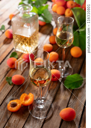 Apricot liqueur or grappa and fresh apricots. 116310801
