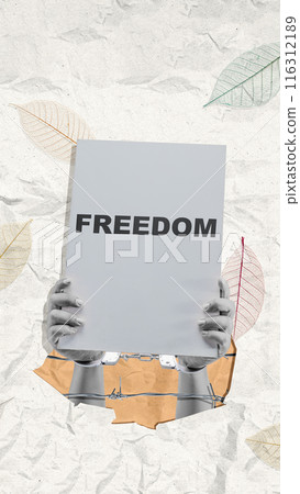 A human hand in a handcuff holding a board with freedom text A human hand in a handcuff holding a board with freedom text 116312189