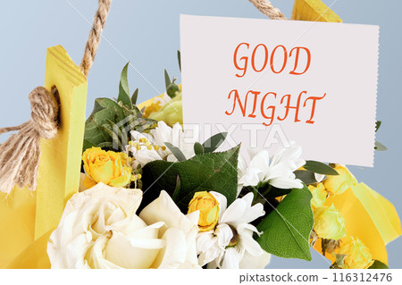 GOOD NIGHT word written on a paper note in a bouquet of flowers GOOD NIGHT word written on a paper note in a bouquet of flowers 116312476