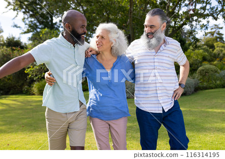 Group of friends walking together in park, enjoying outdoor time 116314195
