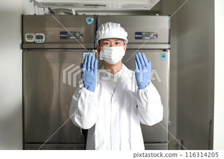 Asian man in sanitary clothing inspecting the kitchen Asian man in sanitary clothing inspecting the kitchen 116314205