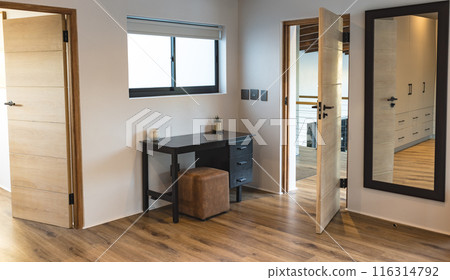 Modern home interior with desk, chair, and large mirror in bedroom, copy space 116314792